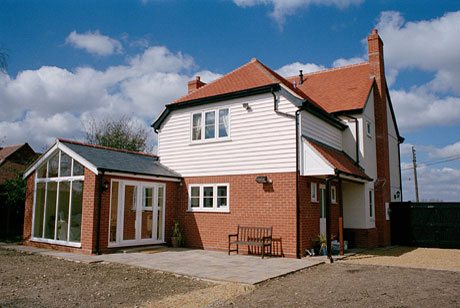 Finished clapboard new build with glass garden room, Maldon
